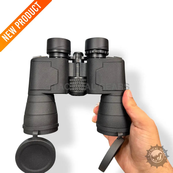 Black Comet 7x50 binoculars with textured grip and lens caps held in hand