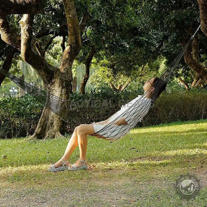 White and black patterned mesh hammock with durable rope, perfect for outdoor relaxation