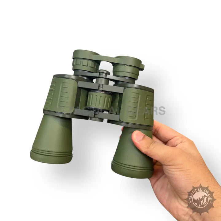 Green binoculars held in hand showcasing Conquest Seeker 20x50 Military Binoculars