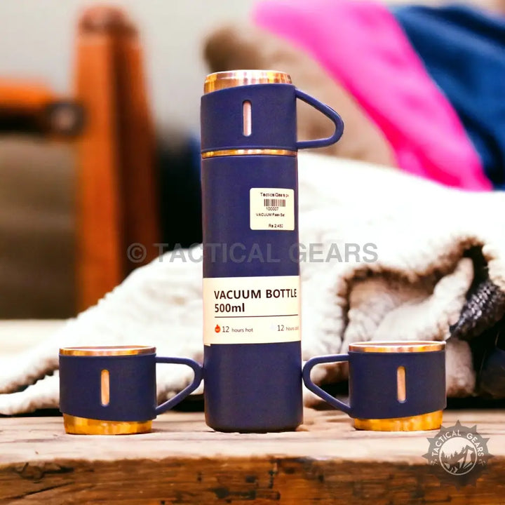 Dark blue vacuum flask set with gold accents and matching cups, keeps liquids hot or cold for 12 hours