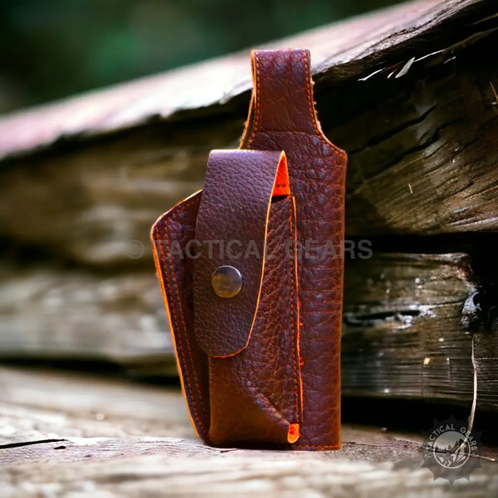Brown leather sheath with orange interior and snap closure for universal cover product