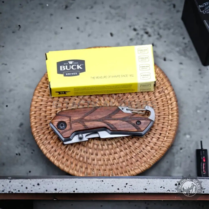 Pocket Folding Knife Buck x84 with a dark wood handle and intricate leaf pattern
