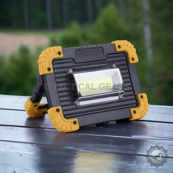 Black and yellow rechargeable flood light with kickstand, ideal for work sites