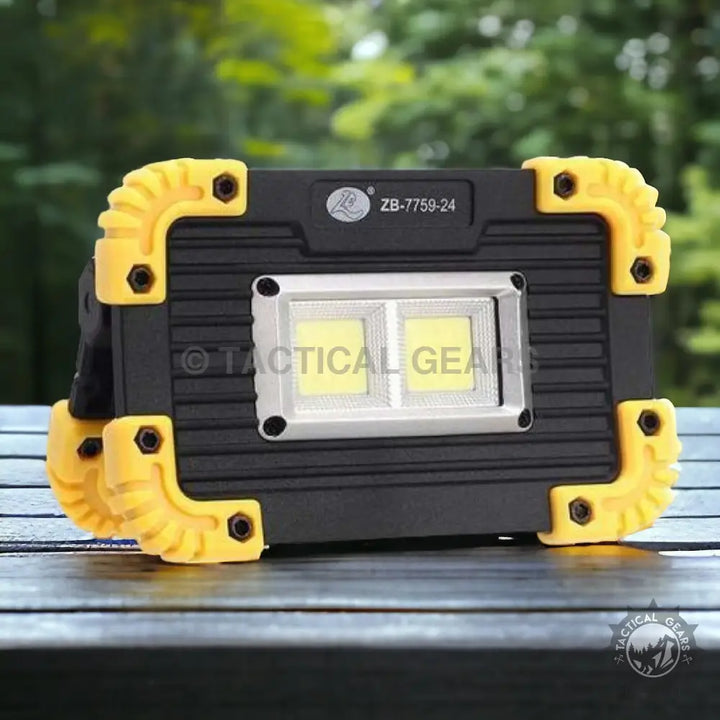 Black and yellow rechargeable flood light with dual COB LEDs for bright portable illumination