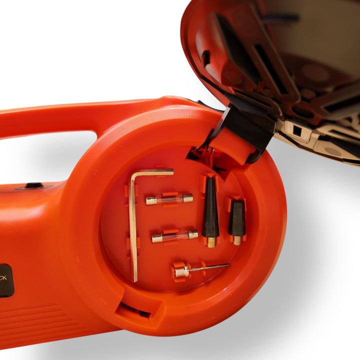 Open orange Electric Car Jack Tool Set with wrench set, fuses, and inflation nozzles