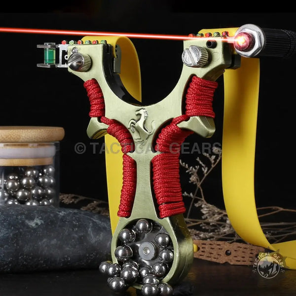 Metallic gold-colored Ferrari Hunting Slingshot with laser, level, and red paracord handle