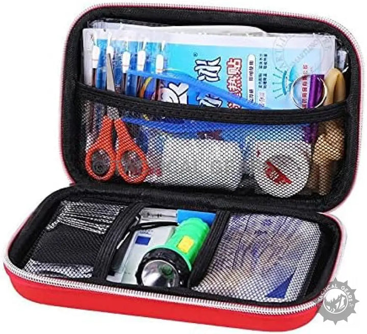 Red compact First Aid Kit filled with medical supplies for emergency use