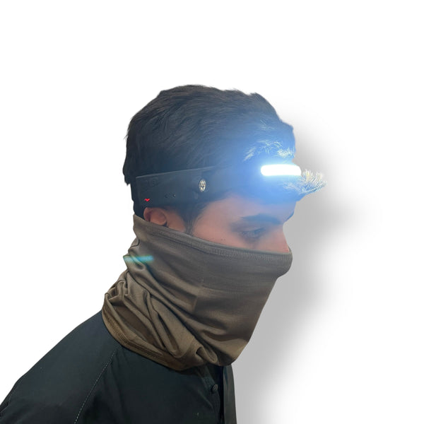 Person wearing a black headlamp with bright white light and brown neck gaiter, flexible LED strip headlamp