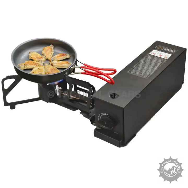 Portable camping stove with frying pan cooking chicken wings, ideal cooking solution