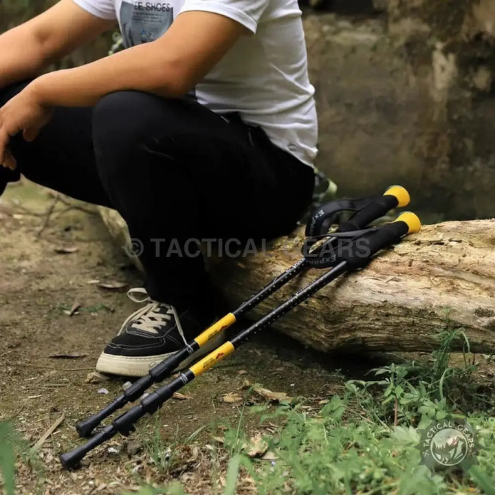 Black trekking stick with yellow accents for Folding Hiking Stick product display