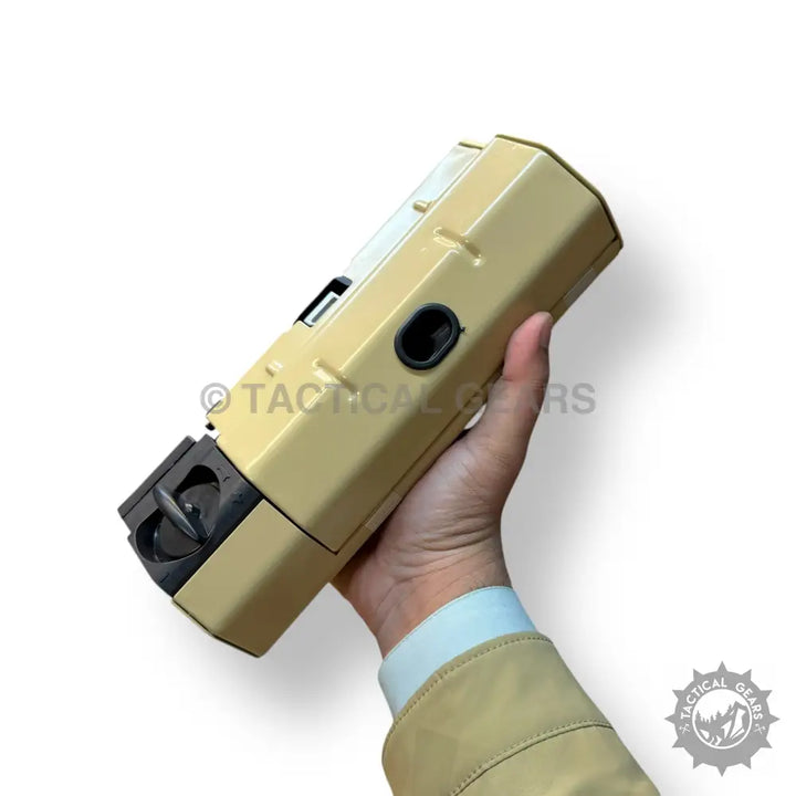Beige folding portable camping stove handheld device with black accents for outdoor cooking