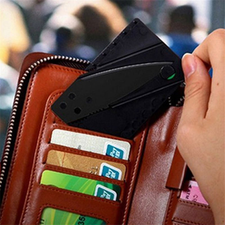 Credit card-sized folding knife being placed into a wallet, Garberiel Black Tactical Sharp Blade Knife