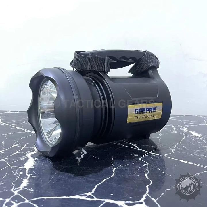 Black handheld LED search light with carrying handle for outdoor activities and security