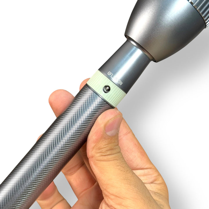 Hand holding Geepas Rechargeable LED Flashlight with textured grip and light-colored ring