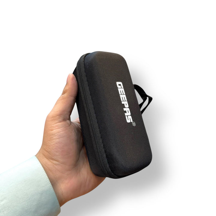 Hand holding a Geepas VIP Series LED Flashlight with Power Bank in a textured black case