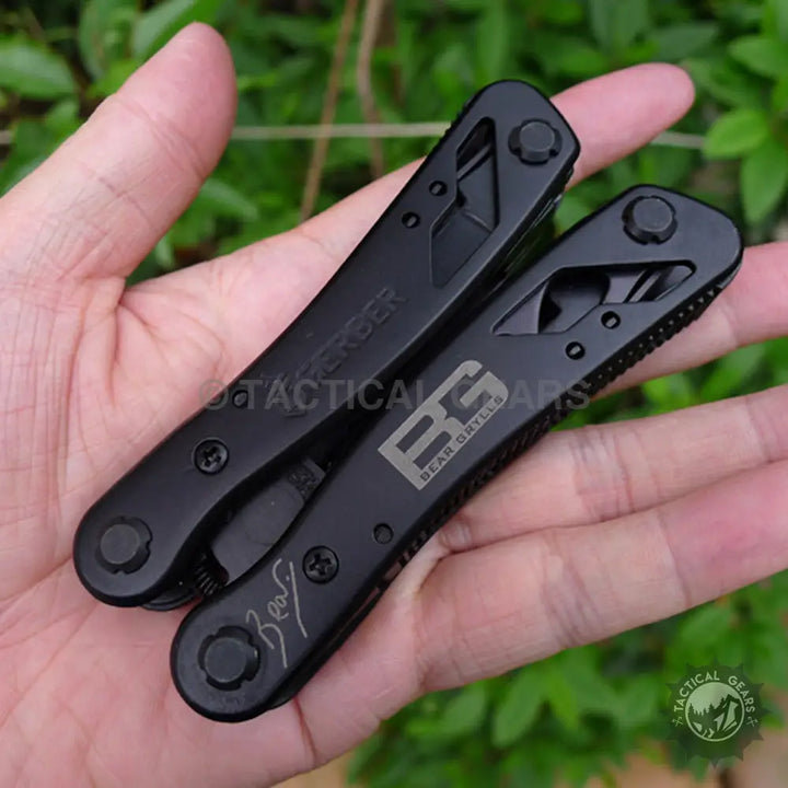 Gerber Bear Grylls Ultimate multi-tool with black textured grips and screwdriver bits