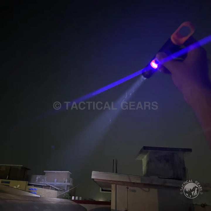 Handheld Ultraviolet Camping Flashlight emitting bright white beam and vibrant blue laser
