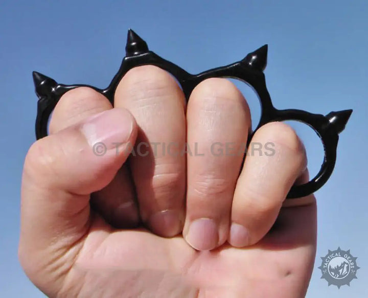 Black metal knuckles with pointed studs for a tough hand grip and protection
