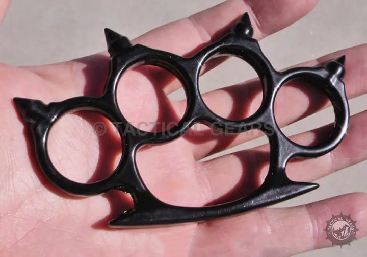 Black metal knuckles with pointed tips for a sturdy hand grip and defense