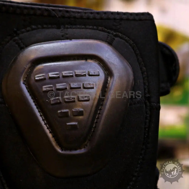 Black tactical glove with hard knuckle protector, ideal for heavy duty knee pads use