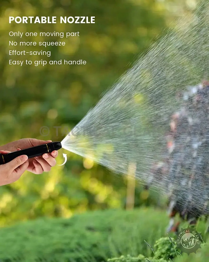 Hand holding a high pressure water nozzle spraying water on a hose pipe