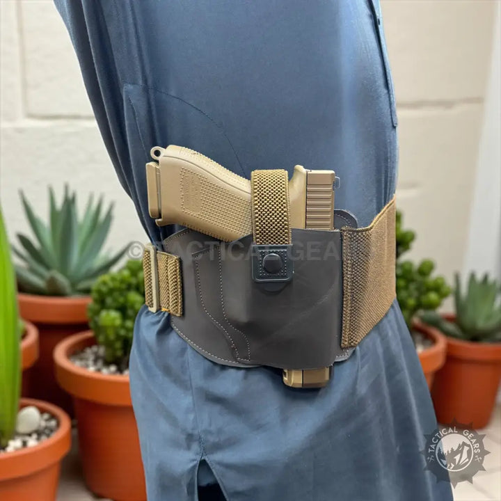 Tan pistol in a black belly band waist holster with tan elastic waistband for concealed carry