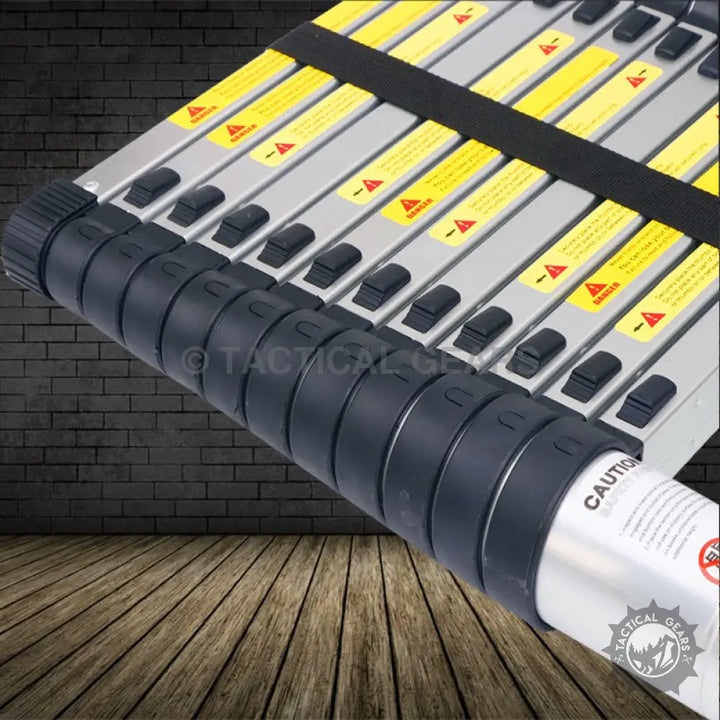 High quality fully extended black and silver telescoping ladder with safety warnings