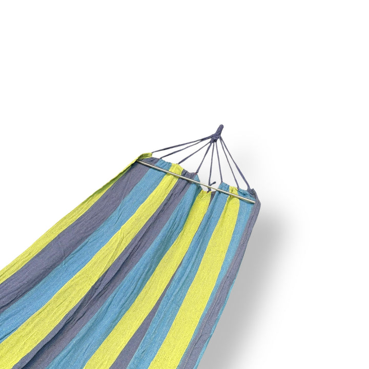 Imported hammock with green striped fabric and spreader bar for relaxing comfort