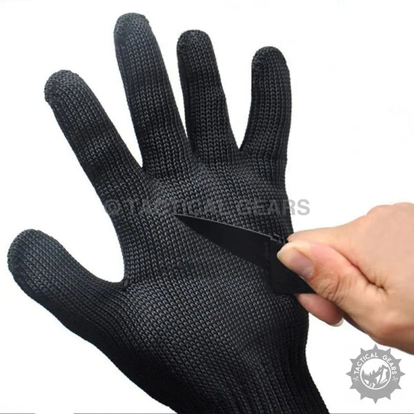 Black anti-cut anti-slip gloves being tested with a knife for safety and durability