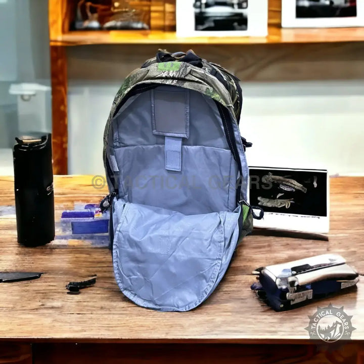 Camo tactical backpack with spacious light blue interior for hiking and camping items