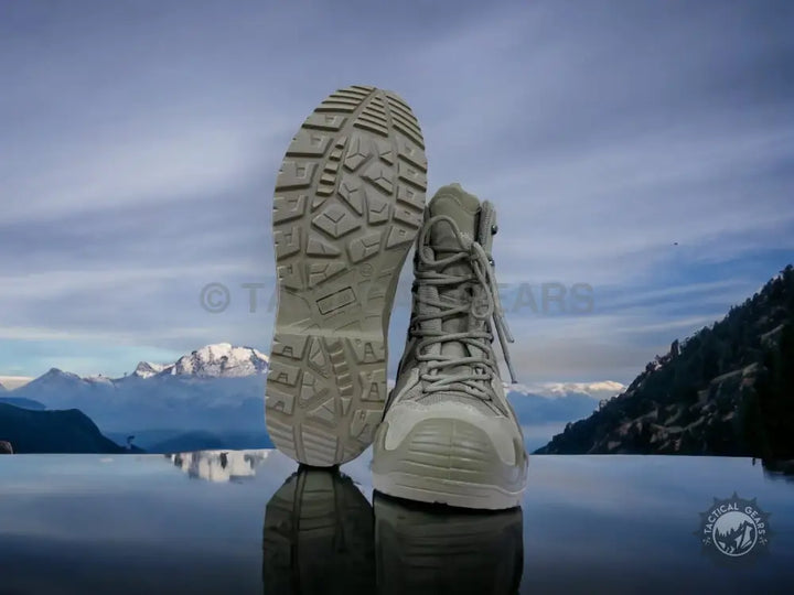 Khaki high-top waterproof tactical boots with rugged soles for hiking and outdoor activities