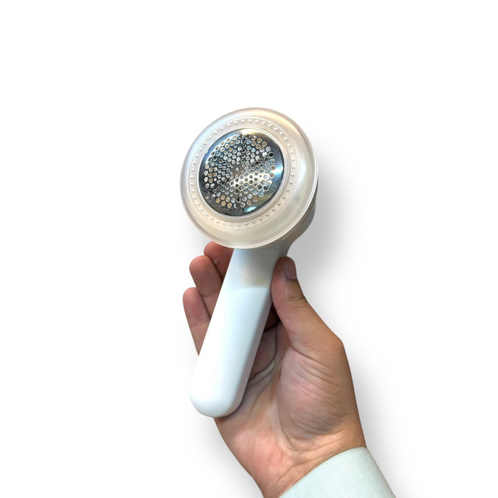 White handheld Kolax Lint Remover with clear top and metallic lint collector