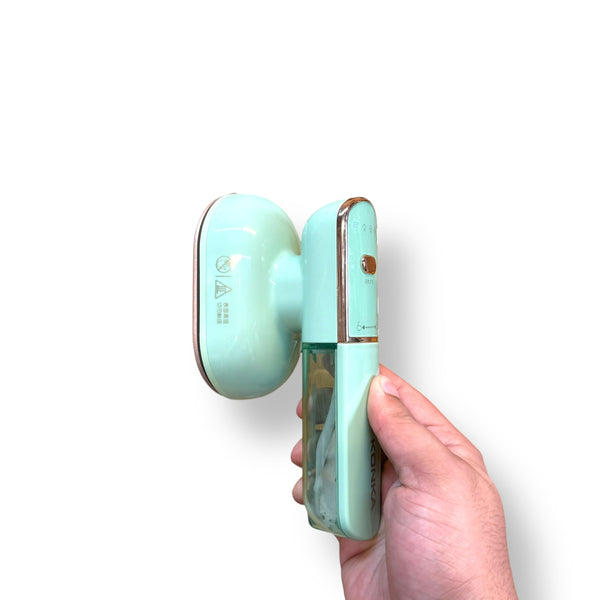 Konka Travelling Steam Iron with mint green design, clear water tank, and rose gold accents