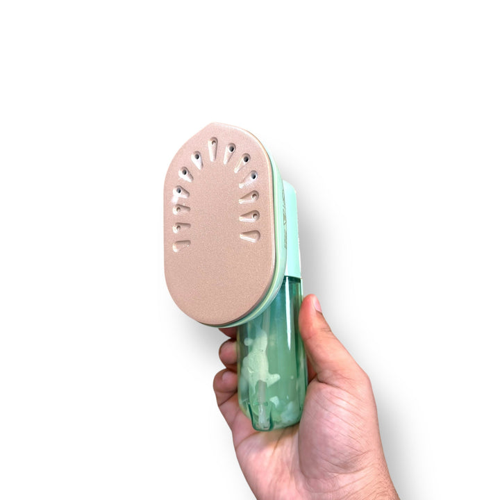 Konka Travelling Steam Iron with mint green body and peach-colored steam vents