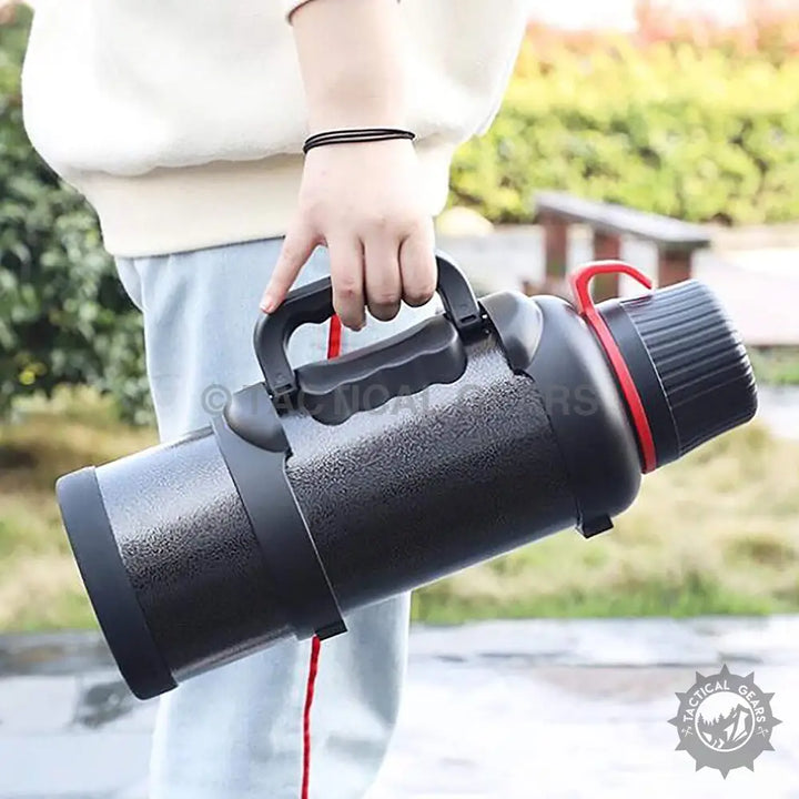 Black textured insulated water bottle with handle and red ring, ideal travel accessories