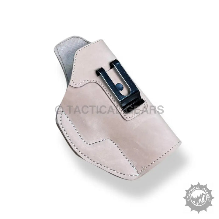 Light-colored leather gun holster with black metal belt clip for easy 9MM carry