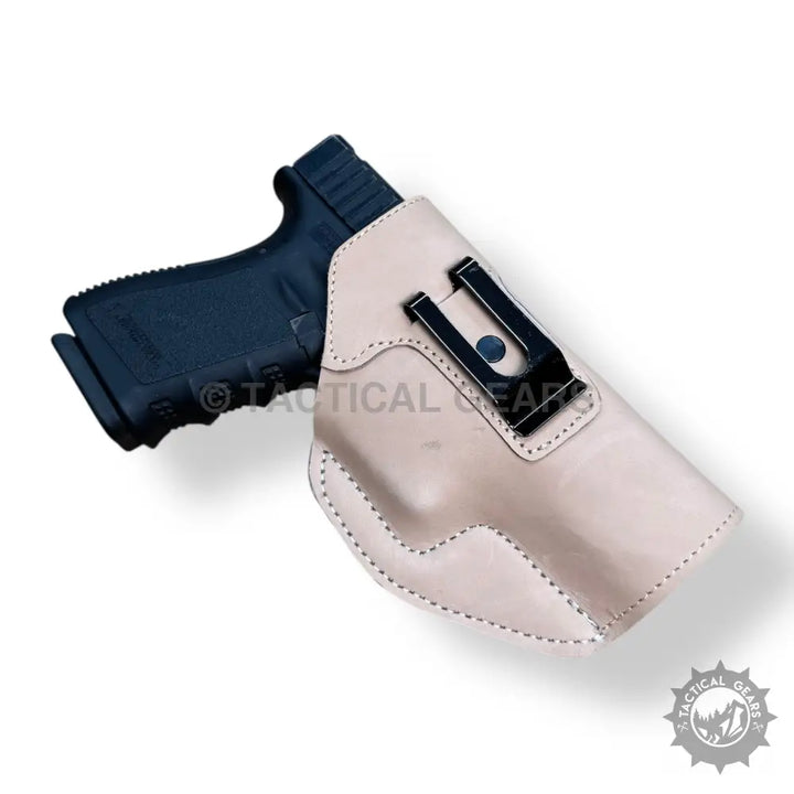 Easy-to-use black handgun in light-colored leather holster with black clip for 9MM
