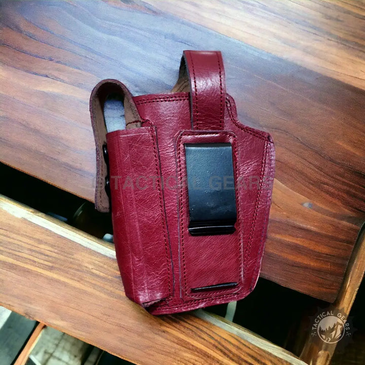 Red leather pistol holster with belt clip for firearm enthusiasts and concealed carry