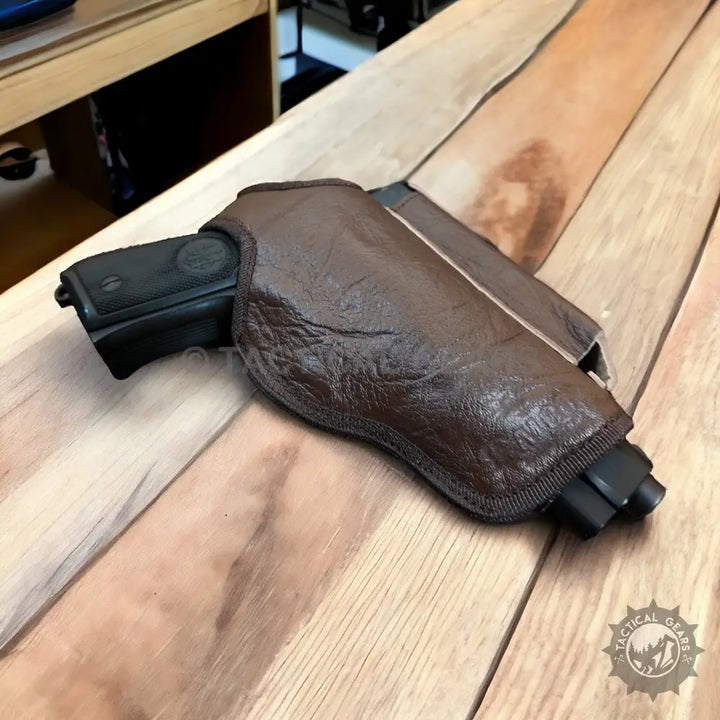 Brown leather gun holster with mag pouch and black pistol for right and left hand use