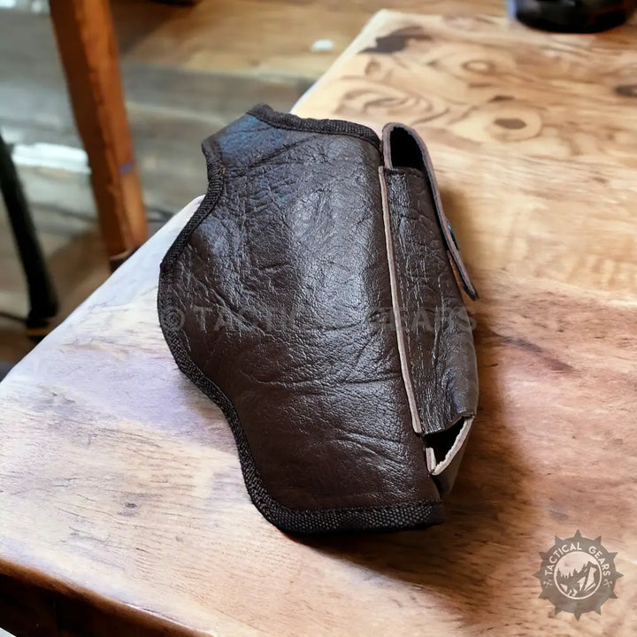 Brown leather pistol holster with black trim and mag pouch for right and left hand use