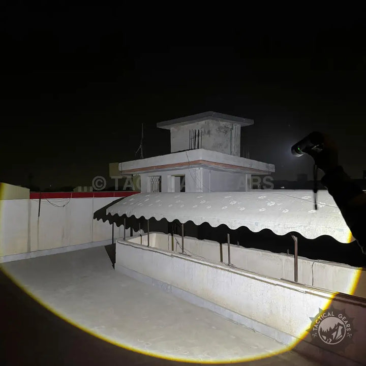 Rooftop building at night illuminated by P90 Tactical Flashlight, imported P90 flashlight