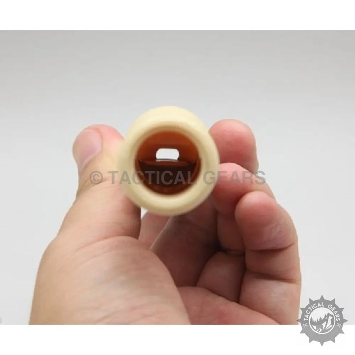 Light-colored hollow cylindrical duck caller with internal rectangular opening for hunting