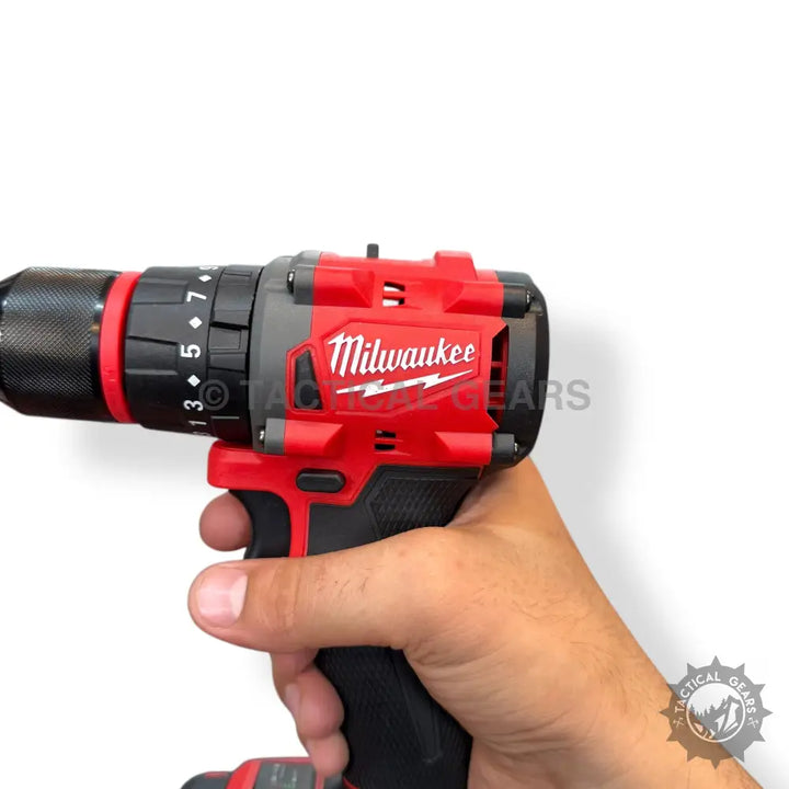 Red and black Milwaukee M18 FUEL rechargeable drill with battery pack held by hand