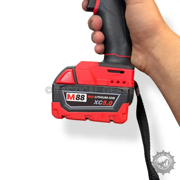 Red and black M18 rechargeable battery pack for Milwaukee drill held by hand