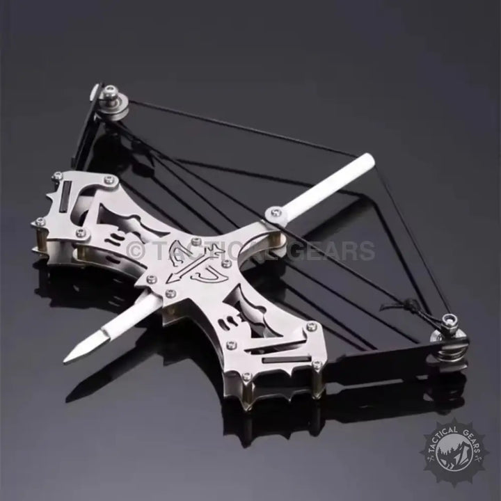 Mini compound bow with metallic finish, elastic string, and pointed projectile for precision shooting