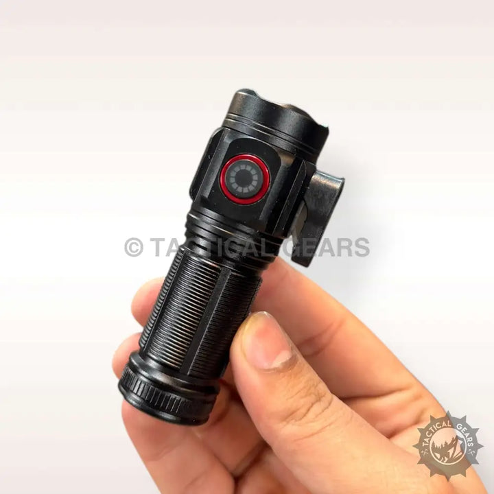 Black compact tactical flashlight with a red-ringed control button.
