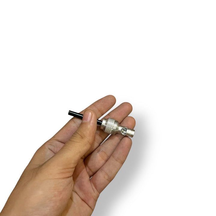 Person’s hand holding a silver BNC connector with black cable on Multi Tactical Shovel