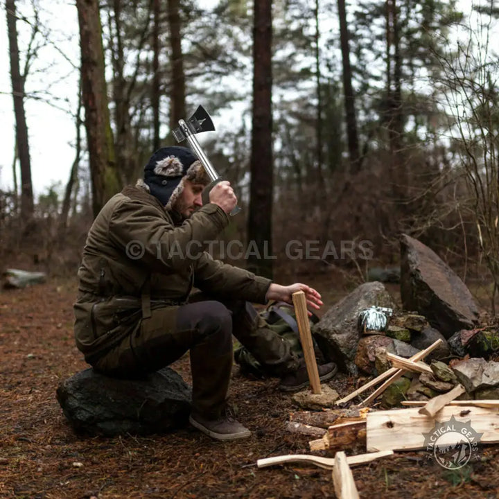 Man using Multifaceted Outdoor Camping Shovel with 4cm x 4cm and 7cm x 4cm blades for wood chopping
