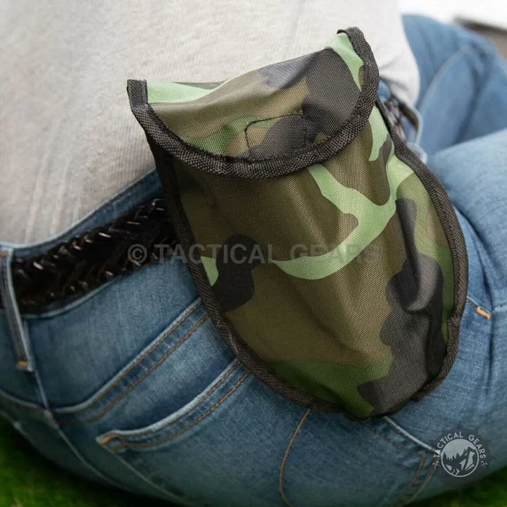 Camouflage-patterned fabric pouch with dark trim for portable camping shovel storage