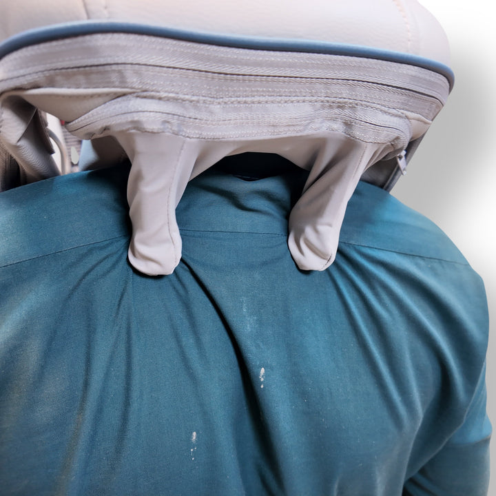 Light-colored gloves tucked into teal shirt with Neck Massager HJ-188 for comfort